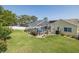 Aerial view of the backyard with a screened-in pool and lush green lawn at 1049 Larkin Rd, Spring Hill, FL 34608