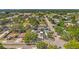 Aerial view of neighborhood with lush trees, green spaces and a view to the horizon at 1115 Pennsylvania Ave, Palm Harbor, FL 34683
