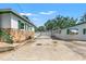 Spacious backyard featuring a house and detached garage with an access gate for privacy at 1115 Pennsylvania Ave, Palm Harbor, FL 34683