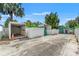 Exterior view of backyard buildings, garages, and gated entrance at 1115 Pennsylvania Ave, Palm Harbor, FL 34683
