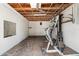 Unfinished basement with exposed ceiling and cinder block walls, featuring a home gym at 1115 Pennsylvania Ave, Palm Harbor, FL 34683