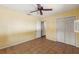 Bedroom with a ceiling fan, tiled floors, closet, and access to additional rooms at 1115 Pennsylvania Ave, Palm Harbor, FL 34683