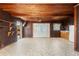 Spacious bonus room with wood-paneled ceiling and walls, tile floor, and double doors leading to the outside at 1115 Pennsylvania Ave, Palm Harbor, FL 34683
