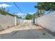 Long driveway lined with walls leads to a gated entrance at 1115 Pennsylvania Ave, Palm Harbor, FL 34683