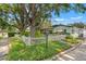 Charming home with a white picket fence and lush landscaping at 1115 Pennsylvania Ave, Palm Harbor, FL 34683