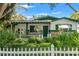 Charming single story home with a white picket fence and beautiful front yard landscaping at 1115 Pennsylvania Ave, Palm Harbor, FL 34683