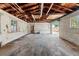 Interior view of garage space with unfinished walls, wood ceiling, and overhead lighting at 1115 Pennsylvania Ave, Palm Harbor, FL 34683