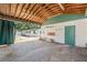 View of garage area with open carport and storage at 1115 Pennsylvania Ave, Palm Harbor, FL 34683