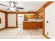Kitchen features exposed wood beams, tiled floors, and an island with sink at 1115 Pennsylvania Ave, Palm Harbor, FL 34683