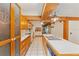 Bright kitchen with wood cabinets, an island with sink, and white appliances at 1115 Pennsylvania Ave, Palm Harbor, FL 34683