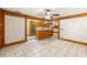Open concept kitchen with island, wood accents, and tile flooring at 1115 Pennsylvania Ave, Palm Harbor, FL 34683