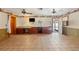 Spacious living room with tile flooring, custom built-ins, and an outdoor patio entrance at 1115 Pennsylvania Ave, Palm Harbor, FL 34683