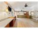 Open living area featuring tile floors, a decorative stone wall, and two ceiling fans at 1115 Pennsylvania Ave, Palm Harbor, FL 34683