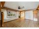 Living room with ceramic tile flooring and decorative wallpaper at 1115 Pennsylvania Ave, Palm Harbor, FL 34683