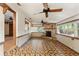 Cozy living room with brick fireplace and brick-patterned tile floor at 1115 Pennsylvania Ave, Palm Harbor, FL 34683