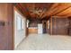 Versatile living space with wood paneled walls, tile flooring, and abundant natural light at 1115 Pennsylvania Ave, Palm Harbor, FL 34683