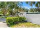 Charming single story home with white picket fence, lush landscaping, and a privacy wall with home address at 1115 Pennsylvania Ave, Palm Harbor, FL 34683