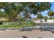 Charming single story home with lush landscaping, white picket fence, and rear parking court at 1115 Pennsylvania Ave, Palm Harbor, FL 34683