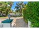 Beautiful landscaping and a concrete block fence create a private oasis at 1115 Pennsylvania Ave, Palm Harbor, FL 34683