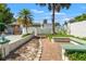 Paver pathway and bench seating compliment the privacy wall creating a serene outdoor space at 1115 Pennsylvania Ave, Palm Harbor, FL 34683