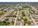 Aerial view showing the home's location within a residential neighborhood filled with mature trees at 11192 Archer Ave, Spring Hill, FL 34608