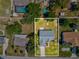 An aerial view of the property shows the house, driveway and surrounding lawn area at 11192 Archer Ave, Spring Hill, FL 34608
