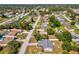 Aerial view shows a single Gathering home with fenced yard in a residential neighborhood dotted with mature shade trees at 11192 Archer Ave, Spring Hill, FL 34608