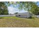 Lush backyard featuring healthy grass and dead grass, white vinyl fence, and trees offering shade and privacy at 11192 Archer Ave, Spring Hill, FL 34608