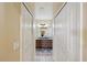 Hallway view of a bathroom vanity with double sinks and a mirror at 11192 Archer Ave, Spring Hill, FL 34608