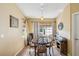 Dining room with a round table, four chairs, patterned drapes, and a decorative wall hanging at 11192 Archer Ave, Spring Hill, FL 34608