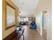Hallway view showcasing the home's tile flooring, large mirror, with an opening to the living room at 11192 Archer Ave, Spring Hill, FL 34608