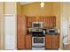 Well-equipped kitchen with stainless steel appliances, wood cabinetry, granite countertops, and ample storage at 11192 Archer Ave, Spring Hill, FL 34608