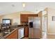 Kitchen area with stainless steel appliances, granite countertops, sink, and cabinetry at 11192 Archer Ave, Spring Hill, FL 34608