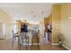 Open kitchen with granite countertops, island with bar seating, and tile flooring at 11192 Archer Ave, Spring Hill, FL 34608