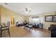 Spacious living room with tile floors, sofas, large window offering natural light, and easy access to other rooms at 11192 Archer Ave, Spring Hill, FL 34608