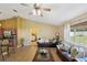 Inviting living room with tile floors, comfortable seating, natural light, and an open layout at 11192 Archer Ave, Spring Hill, FL 34608