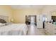 Spacious main bedroom featuring light walls, tiled flooring, and views into adjacent rooms at 11192 Archer Ave, Spring Hill, FL 34608