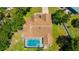 Aerial view of a home with a screened-in pool and meticulously maintained roof at 11291 Countrywood Ct, Spring Hill, FL 34609