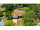 Aerial shot of a home with a screened-in pool and lush greenery at 11291 Countrywood Ct, Spring Hill, FL 34609
