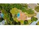 Aerial view of a private residence featuring a sparkling pool and lush landscaping at 11291 Countrywood Ct, Spring Hill, FL 34609