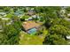 Aerial view of a home with a screened-in pool, surrounded by mature trees and landscaping at 11291 Countrywood Ct, Spring Hill, FL 34609