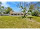Large backyard with a screened-in pool area, perfect for outdoor entertaining at 11291 Countrywood Ct, Spring Hill, FL 34609