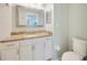 Bathroom featuring a granite vanity, tiled walls, and modern fixtures at 11291 Countrywood Ct, Spring Hill, FL 34609