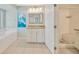 Bright bathroom with soaking tub, granite vanity, and walk-in shower at 11291 Countrywood Ct, Spring Hill, FL 34609