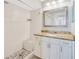 Bathroom with white cabinets, granite vanity, walk-in shower and decorative tile at 11291 Countrywood Ct, Spring Hill, FL 34609