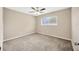 Carpeted bedroom with ceiling fan and large window at 11291 Countrywood Ct, Spring Hill, FL 34609
