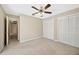This spacious bedroom has a ceiling fan and ample closet space at 11291 Countrywood Ct, Spring Hill, FL 34609
