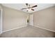 The bedroom features a ceiling fan and neutral carpet at 11291 Countrywood Ct, Spring Hill, FL 34609