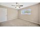 This bedroom features a ceiling fan and a bright window at 11291 Countrywood Ct, Spring Hill, FL 34609