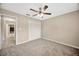 Carpeted bedroom with ceiling fan and closet at 11291 Countrywood Ct, Spring Hill, FL 34609